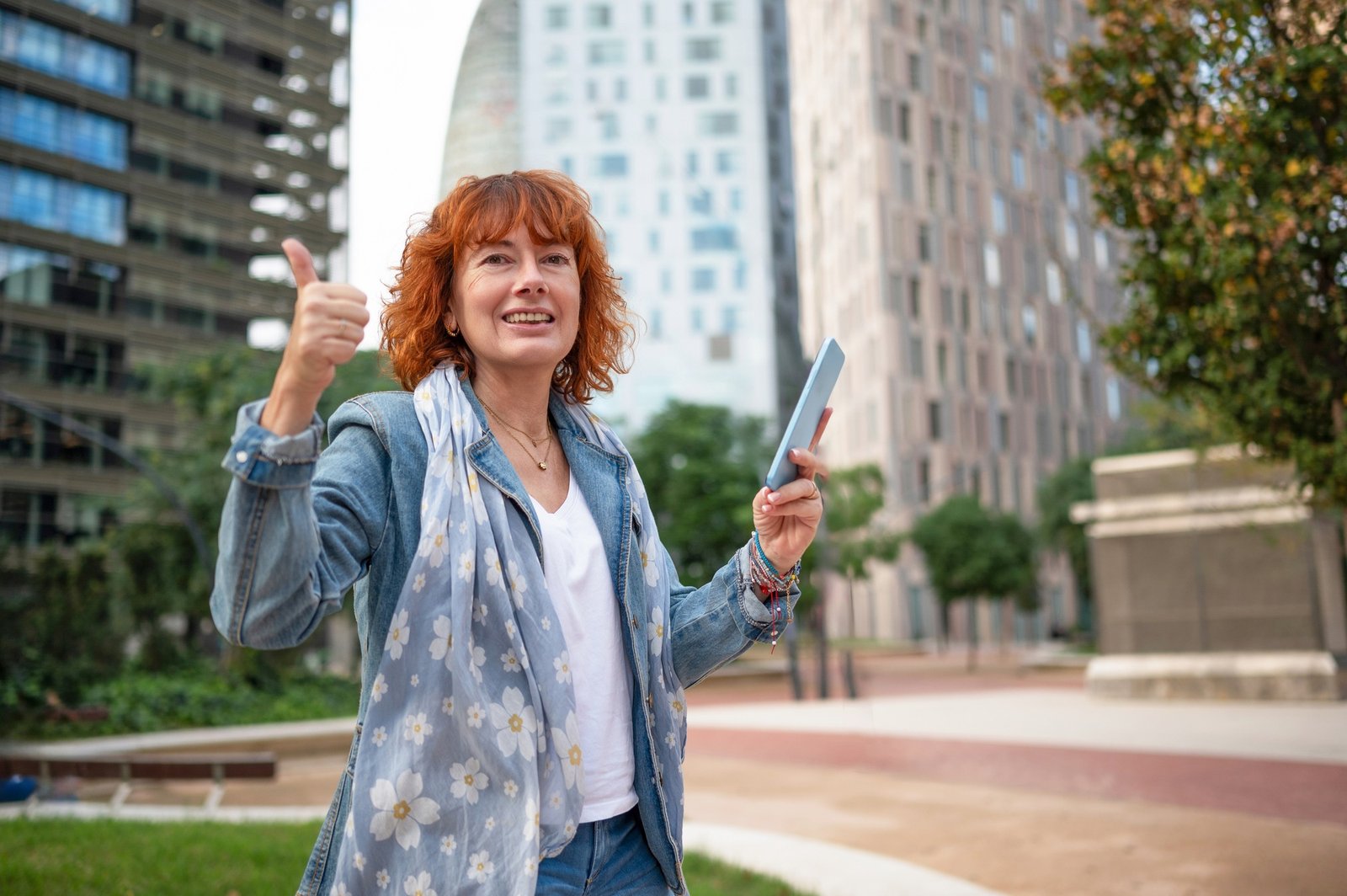 Happy tourist gesturing thumbs up while using smartphone in barc